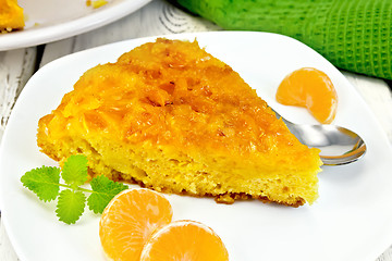 Image showing Pie mandarin with mint and spoon on board