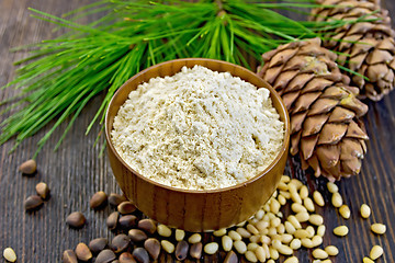 Image showing Flour cedar in bowl nuts on board