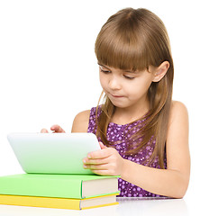 Image showing Young girl is using tablet