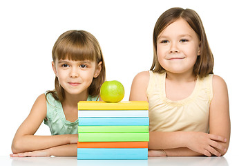 Image showing Little girls with books and apple