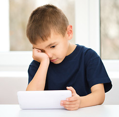 Image showing Young boy is using tablet