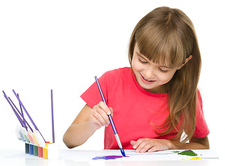 Image showing Little girl is painting with gouache