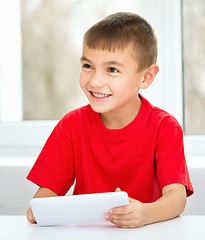 Image showing Young boy is using tablet