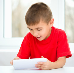 Image showing Young boy is using tablet