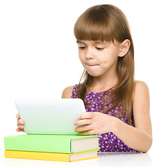 Image showing Young girl is using tablet