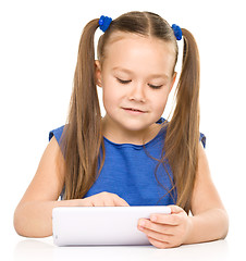 Image showing Young cheerful girl is using tablet