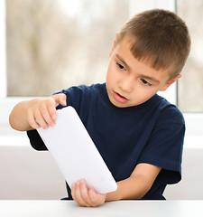 Image showing Young boy is using tablet