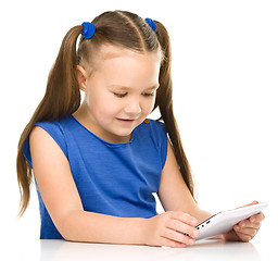 Image showing Young girl is using tablet