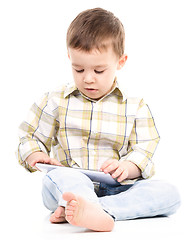 Image showing Young boy is using tablet