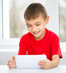 Image showing Young boy is using tablet