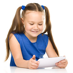 Image showing Young cheerful girl is using tablet