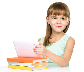 Image showing Young girl is using tablet