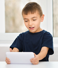 Image showing Young boy is using tablet