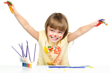 Image showing Portrait of a cute girl playing with paints