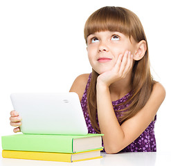 Image showing Young girl is using tablet