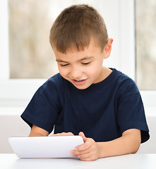 Image showing Young boy is using tablet