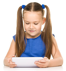 Image showing Young girl is using tablet