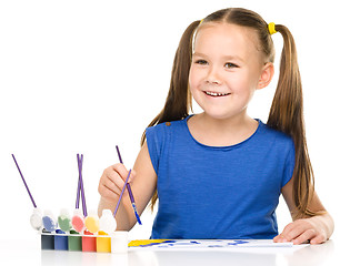 Image showing Little girl is painting with gouache