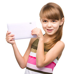 Image showing Young girl is using tablet