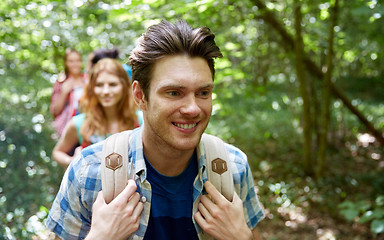 Image showing group of smiling friends with backpacks hiking