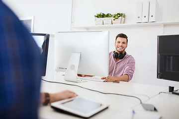 Image showing creative man with headphones and computer