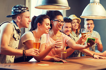 Image showing happy friends with smartphone taking selfie at bar