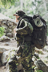 Image showing young soldier with backpack in forest