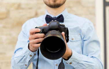 Image showing close up of male photographer with digital camera