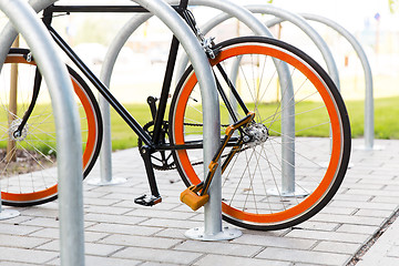 Image showing close up of bicycle locked at street parking