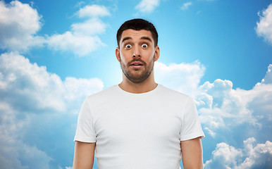 Image showing scared man in white t-shirt over sky background