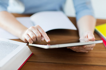 Image showing close up of student with tablet pc and notebook