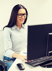 Image showing smiling businesswoman or student with eyeglasses