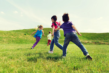 Image showing group of happy kids running outdoors