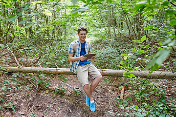 Image showing happy man with backpack and tablet pc in woods