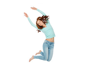 Image showing smiling young woman jumping in air