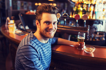 Image showing happy man drinking beer at bar or pub