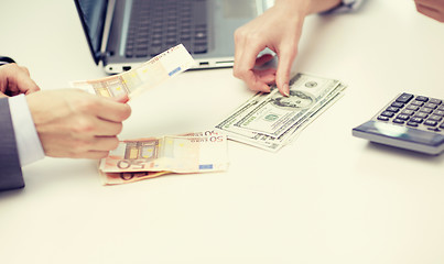 Image showing close up of hands counting money at office