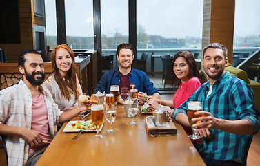 Image showing friends dining and drinking beer at restaurant