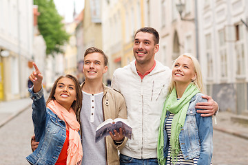 Image showing group of friends with city guide exploring town