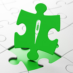 Image showing Medicine concept: Thermometer on puzzle background