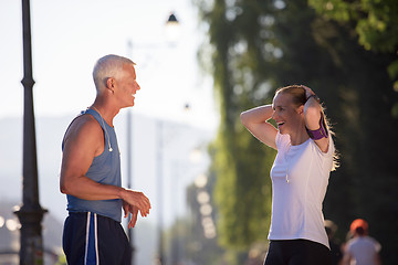 Image showing jogging couple planning running route  and setting music