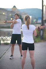 Image showing couple warming up before jogging