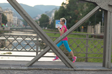 Image showing sporty woman running  on sidewalk