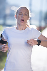 Image showing sporty woman running  on sidewalk