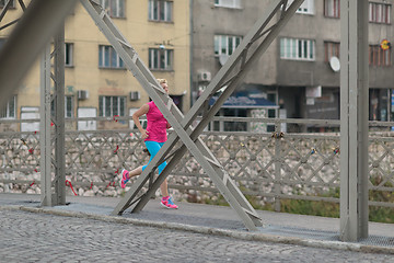 Image showing sporty woman running  on sidewalk