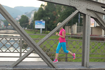 Image showing sporty woman running  on sidewalk