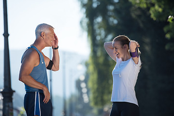 Image showing jogging couple planning running route  and setting music