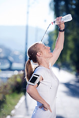 Image showing woman drinking  water after  jogging