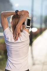 Image showing blonde woman  stretching before morning jogging