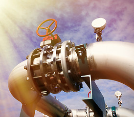 Image showing Industrial zone, Steel pipelines and valves against blue sky